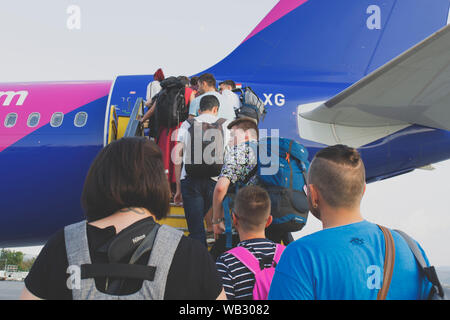 Die Menschen in der Schlange in eine WizzAir flugzeug zu erhalten Stockfoto