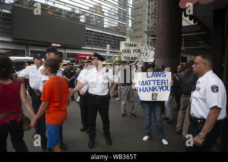 August 23, 2019 - New York Polizei steht vor anti-Demonstranten während eines Protestes gegen Greyhound Corporation und Eis (Einreise Zoll- und Durchsetzung) am Port Authority Bus Terminal in der 42. und 8. Avenue in New York, New York. Über 100 Aktivistinnen aus einer Koalition von Gruppen einschließlich Feuer (für ausländische Flüchtlinge überall Kämpfen) Greyhound, EIS Agenten ihre Busse 'suchen für Migranten zu protestiert", sagten Beamte. Credit: Brian Zweig Preis/ZUMA Draht/Alamy leben Nachrichten Stockfoto