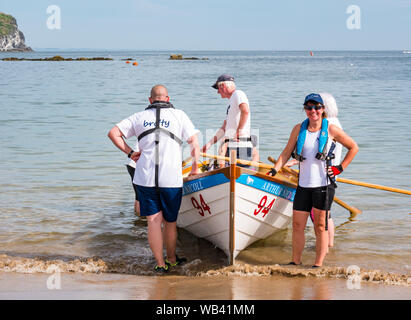 North Berwick, Schottland, Großbritannien, 24. August 2019. Farbenfrohe Ruderskiffe, die an der Regatta aus 12 Clubs in ganz Schottland teilnehmen, treten an einem heißen sonnigen Wochenende an, und rudern 2.5 km um Craigleith Island herum. Der St. Ayles' Skiff ist ein traditionelles Ruderboot mit 4 Ruderbooten. Das Rowing Club Boot und Team der Broughty Ferry Stockfoto