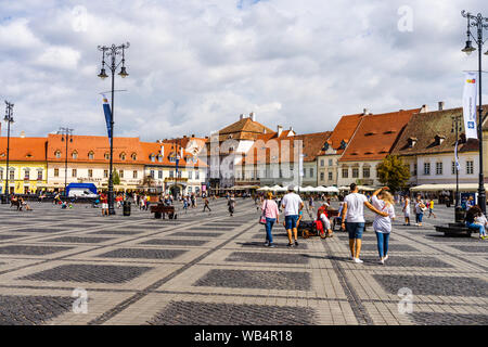 Sibiu, Rumänien - 2019. Touristische Fragen in den Panoramablick auf dem großen Platz (Piaţa Mare) von Sibiu suchen und das Rathaus. Stockfoto