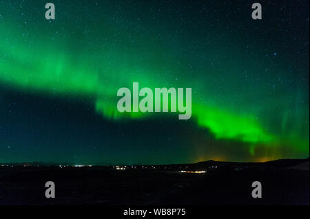 Starke Aktivität von Northern Lights in Island mit charakteristischen lebhaftes Grün leuchten und seltsame Bewegung liefern eine abstrakte Muster, April 2018 Stockfoto