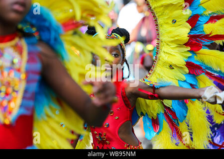 Kid Tänzerin in einem Kostüm während die Kinder Parade auf die Familie Tag der Notting Hill Carnival in London. Tausende von nachtschwärmern Teil in Notting Hill Carnival, Europas größtem Straßenfest und eine Feier der Karibischen Traditionen und kulturellen Vielfalt der Hauptstadt. Stockfoto