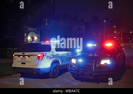 Ein paar Detroit Fahrzeuge der Polizei in der Straße in der Nacht geparkt mit Warnblinkleuchten blinken. Stockfoto