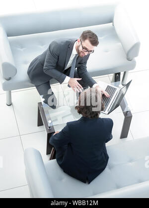 Zwei Geschäftsleute über Aufgaben im Büro sitzen. Stockfoto