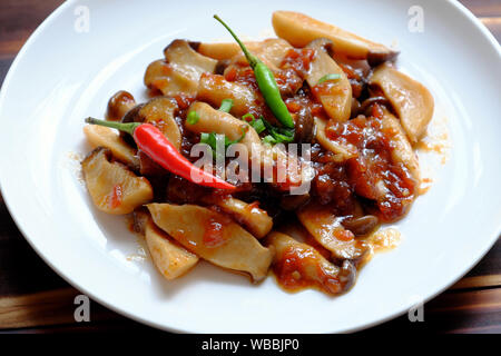 Ansicht von oben Nahaufnahme hausgemachte Speisen auf weiße Platte, König Oyster mushroom Kochen mit Tomatensoße, einfache Mahlzeit, gesundes Essen für Vegetarier Stockfoto