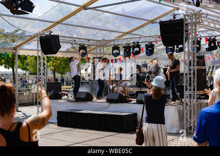 Stadtfest Brugg 25 August 2019. street photography. Band Mitglieder macht Hand klatschen und Publikum, die zwei Kinder, die ein Lied auf Gitarre spielen applaudieren Stockfoto