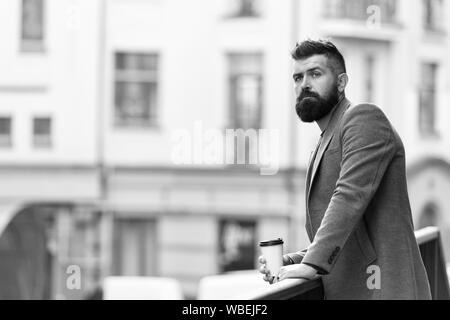 Entspannen und erholen Sie sich. Man bärtige hipster Kaffee trinken Pappbecher. Noch ein Schluck Kaffee. Stadt Lebensstil. Geschäftsmann gepflegt aussehen genießen Sie Kaffee Pause aus Business Center im städtischen Hintergrund. Stockfoto