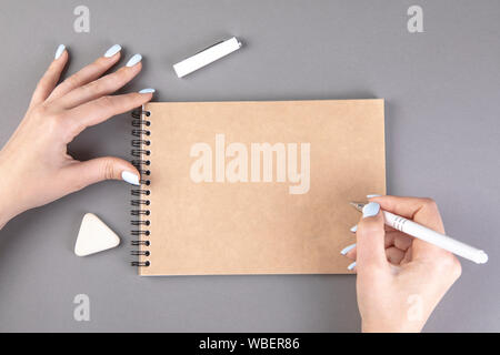 Frau hand mit Bleistift zu schreiben auf Notebook Stockfoto