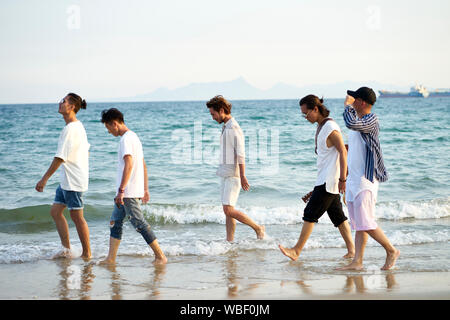 Gruppe von fünf jungen asiatischen Maenner in Meer Wasser am Strand. Stockfoto