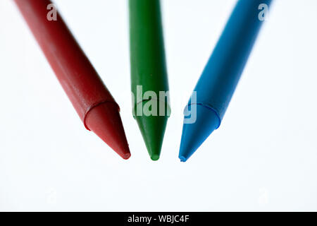 Rot, Grün und Blau Wachsmalstifte vor einem weißen Hintergrund Stockfoto