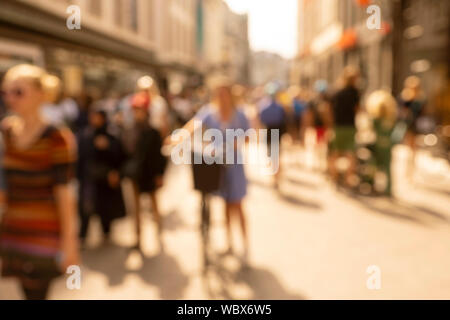 Verschwommen artistitc Bild einer lebhaften Einkaufsstraße voller Menschen an einem sonnigen Sommertag Stockfoto