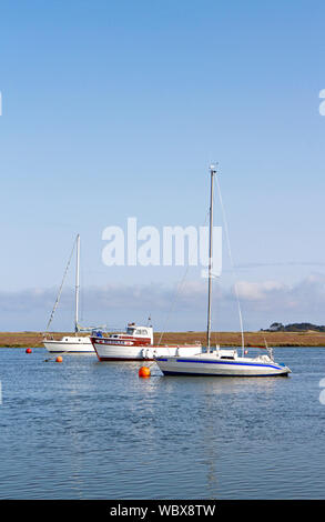 Drei Boote in der Gezeiten- Kanal am östlichen Ende des Hafens an der Brunnen verankert-next-the-Sea, Norfolk, England, Vereinigtes Königreich, Europa. Stockfoto