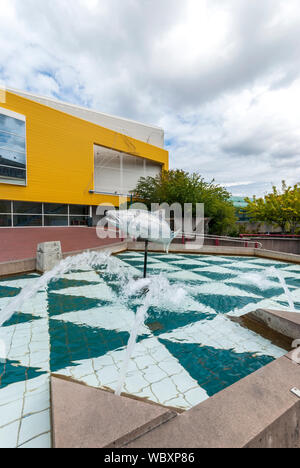 Das Wasser mit einem Lachs Skulptur am Broadway Center für Darstellende Künste in Tacoma, Washington. Stockfoto