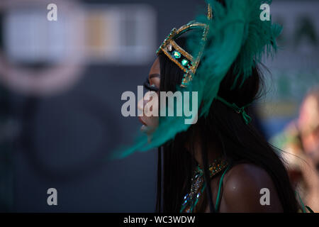 Performerin gekleidet in pfauenfedern an der Notting Hill Carnival, London, UK, größte Karneval in Europa. Stockfoto