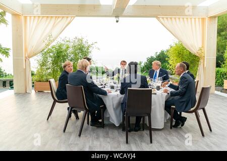 Weltweit führenden Abendessen unter dem massiven Biarritz Leuchtturm während der G7-Führer' Abendessen August 24, 2019 in Biarritz, Frankreich. Sitzend von links nach rechts sind: die deutsche Bundeskanzlerin Angela Merkel, der kanadische Premierminister Justin Trudeau, der französische Präsident Emmanuel Längestrich, US-Präsident Donald Trump, der italienische Ministerpräsident Giuseppe Conte, der Präsident des Europäischen Rates Donald Tusk, der japanische Ministerpräsident Shinzo Abe und der britische Premierminister Boris Johnson. Stockfoto