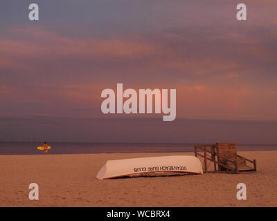 Regenbogen über dem Atlantik von Ocean Beach, New Jersey mit Rettungsschwimmer stehen und Rettungsboot im Vordergrund. Stockfoto