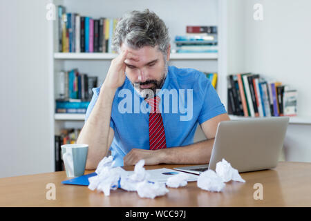 Gestresst und überarbeitet reife Geschäftsmann im Büro Stockfoto