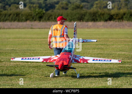 Mike Williams mit Modell Extra 300 aerobatic Flugzeug vor der Teilnahme an kleine und große Formation an der Kleinen Gransden Air & Car Show, Großbritannien Stockfoto
