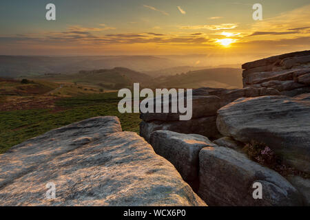 Sonnenuntergang mit untergehenden Sonne auf Higger Tor, Hathersage im Peak District. Dies ist ein beliebtes Ziel für landschaftsfotografen Besucher. Stockfoto