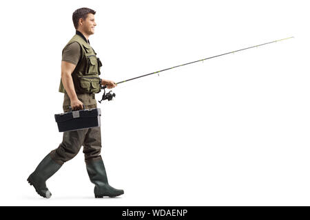 Volle Länge Profil geschossen von einem Fischer mit einer Angelrute zu Fuß auf weißem Hintergrund Stockfoto