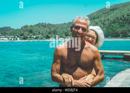 Gerne älteres Paar, das durch das Meer genießen, in den Ruhestand. Ältere Paare umarmte. Summet Zeit. Stockfoto