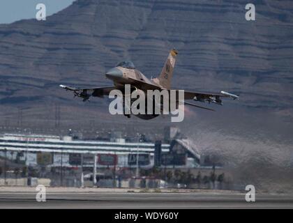 Eine F-16 Fighting Falcon fighter Jet zugeordnet zu den 64th Aggressor Squadron (AGR) zieht aus der Nellis Air Force Base, Nevada, Aug 8, 2019. Die 64 AGR bietet realistische Luft-zu-Luft-Ausbildung an der US Air Force und ihre Verbündeten, der durch Simulation und Replizieren der heutigen Gegner. (U.S. Air Force Foto von Airman 1st Class Bryan Guthrie) Stockfoto