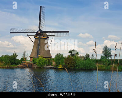 Alte Mühle in der Nähe ein Wasser Kanal bei Kinderdijk Overwaard in den Niederlanden. Mühle von der Unesco zum Weltkulturerbe mit einzigartigen niederländischen Anblick als beliebte touristische Attr Stockfoto