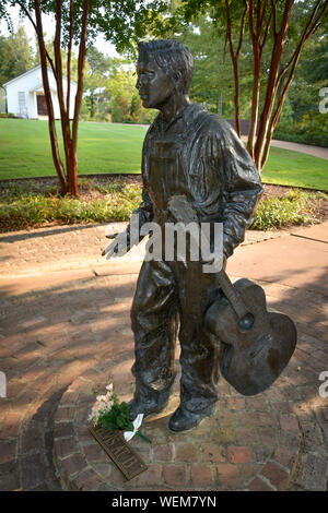 Eine Bronzestatue des 13 Jahre alten Elvis mit Gitarre steht auf dem Weg Besichtigung der Elvis Presley Birthplace Museum gründen in Tupelo, MS, USA Stockfoto