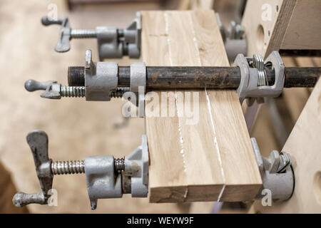 Mit Klemmen und Kleben Holz Hölzer für Möbel Detail zu verbinden. Nähe zu sehen. Stockfoto