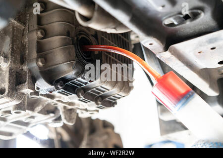 Wechseln des Motoröls in einem Pkw. Fahrzeug auf einer Hebebühne in einem Auto Service Stockfoto