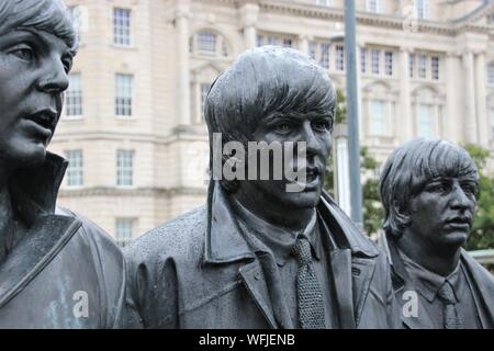 Skulptur der Beatles auf Pier Head, Liverpool, England, bei Regenwetter. Detail: Portrait von Paul, George und Ringo. Artist: Andy Edwards. Europa. Stockfoto