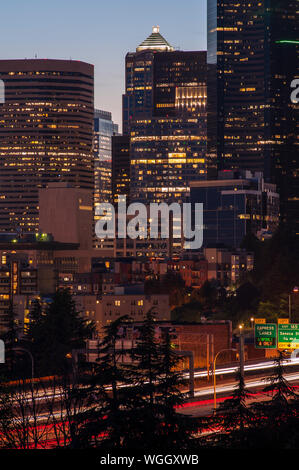 Retro-Bild der Skyline von Seattle bei Sonnenuntergang mit Stadtlichtern und Autoverkehr auf der I-5 Stockfoto