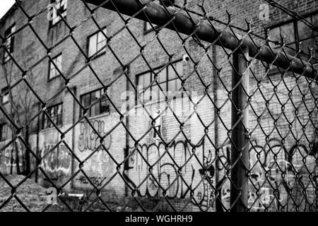 Die einst stolze Gebäude hat zu verrotten hinter einem Maschendrahtzaun gelassen worden, in der Innenstadt von Asheville, NC, USA Stockfoto