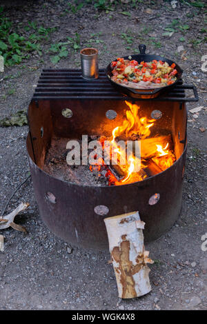 Sommer Camp meal Gusseisen Skillet Speck, Bohnen und Kartoffeln Stockfoto