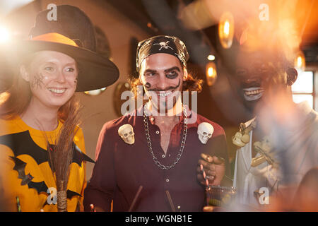 Gruppe erwachsener Freunde tragen Halloween Kostüme genießen Party im Club, auf pirate Mann in der Mitte konzentrieren Stockfoto