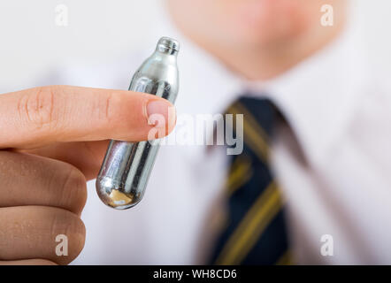 Schüler, die eine Distickstoffoxid (Lachgas) Kanister Stockfoto