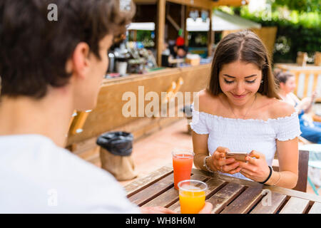 Junges Paar in ein Café, eine Frau mit Smartphone Stockfoto