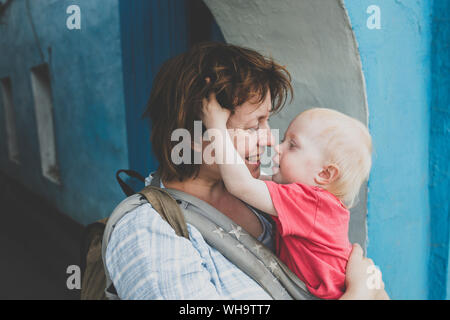 Mutter und ihre kleine Tochter in der Babytrage in einem Augenblick der Zärtlichkeit, Russland Stockfoto