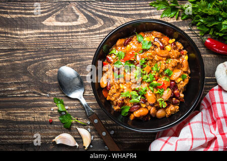 Chili con Carne aus Fleisch und Gemüse auf hölzernen Tischplatte vie Stockfoto