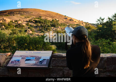 Frau Suchen Münze Teleskop auf eine Beobachtung Schreibtisch betrieben Stockfoto