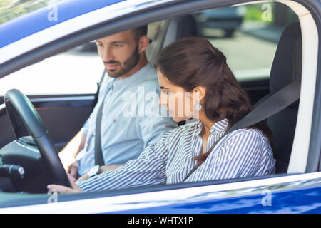 Dunkelhaarige Frau tragen gestreifte Bluse Auto Stockfoto