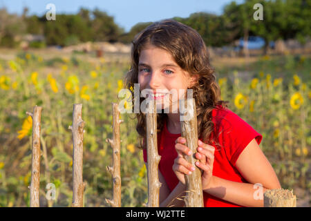 Lächelnder Bauernmädchen mit Sonnenblumen Feld Zaun Tür im Mittelmeer Stockfoto