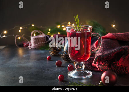 Weihnachten Cranberry und Apple Glühwein garnieren, Rosmarin und Tannenzweigen auf Schwarz. Close Up. Xmas trinken. Stockfoto