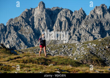 Eine Frau, die in der Nähe der Lacs Merlet Hütte im Parc national de la Vanoise, La Vallee des Avals, Courchevel, Französische Alpen wandert. Stockfoto