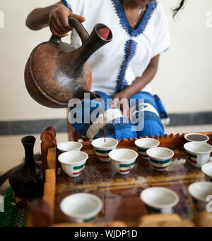 Hand gießen äthiopischen Kaffee während der Kaffee Zeremonie Stockfoto