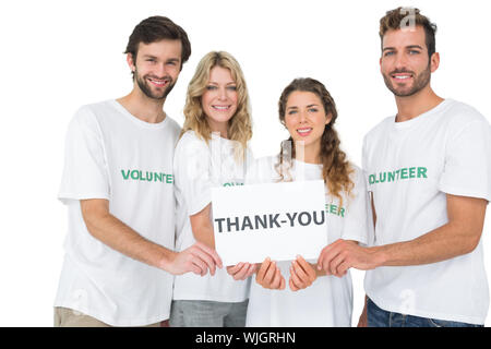 Group Portrait von Happy freiwillige Holding "Danke"-Platine mit weißem Hintergrund Stockfoto