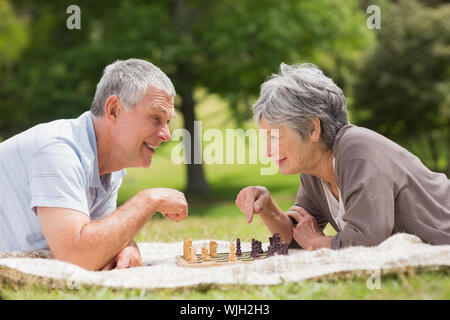 Seitenansicht eines glücklichen Senior paar Schach spielen im Park Stockfoto