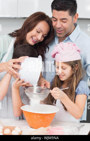 Porträt einer Familie von vier Vorbereitung Cookies in der Küche zu Hause. Stockfoto