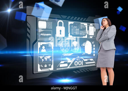 Fokussierte Geschäftsfrau gegen Kästen auf technischer Hintergrund Stockfoto