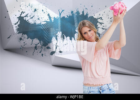 Enttäuscht Frau hält ein Sparschwein auf dem Kopf gegen Spritzer an der Wand offenbart Technologie Grafik Stockfoto